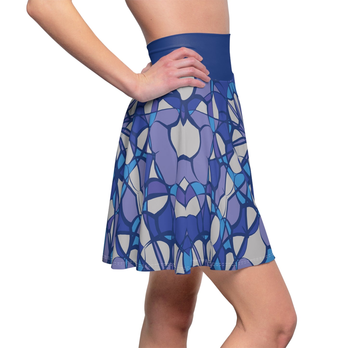 A woman wearing a flared skater skirt with a blue, purple, and gray stained-glass style pattern, shown from the waist down on a white background.