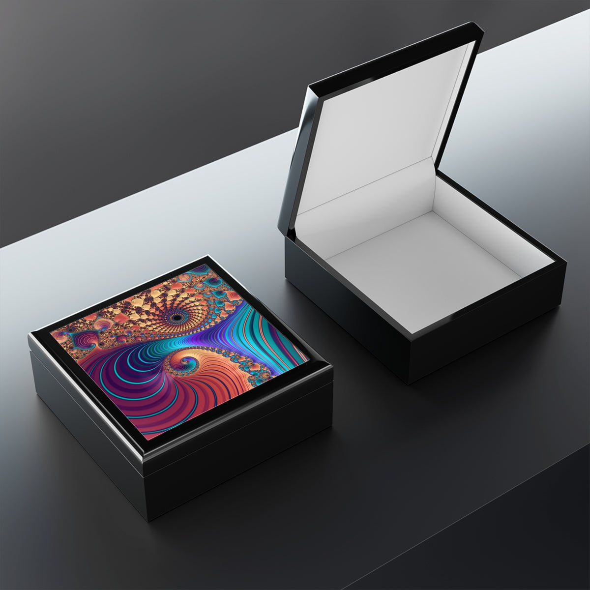 Open black jewelry box with colorful abstract design on a dark surface