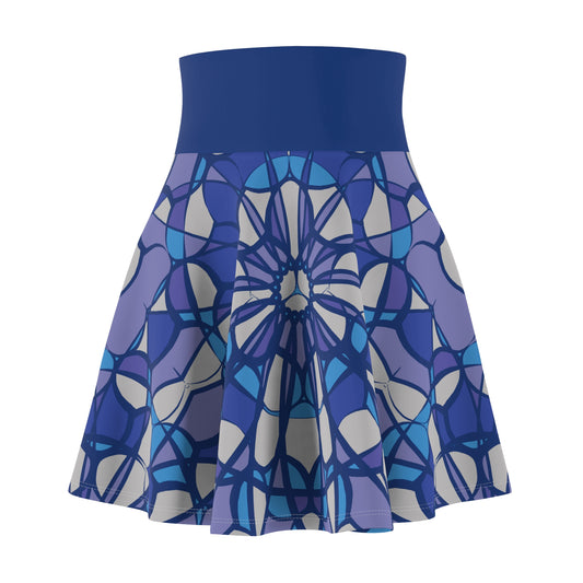 A high-waisted skater skirt with a solid royal blue waistband and a pleated, patterned skirt featuring a stained-glass style geometric design in shades of blue, purple, and gray on a white background.