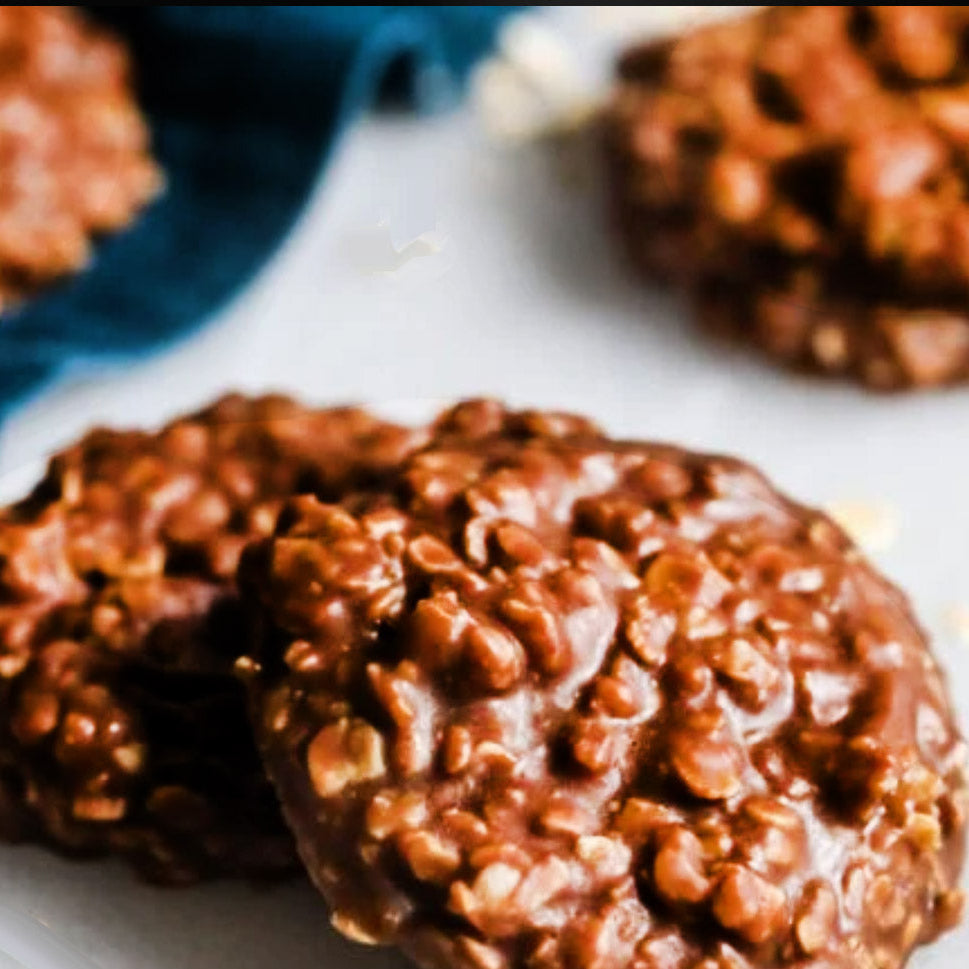 Chocolate cookies on a white surface with a blue napkin in the background