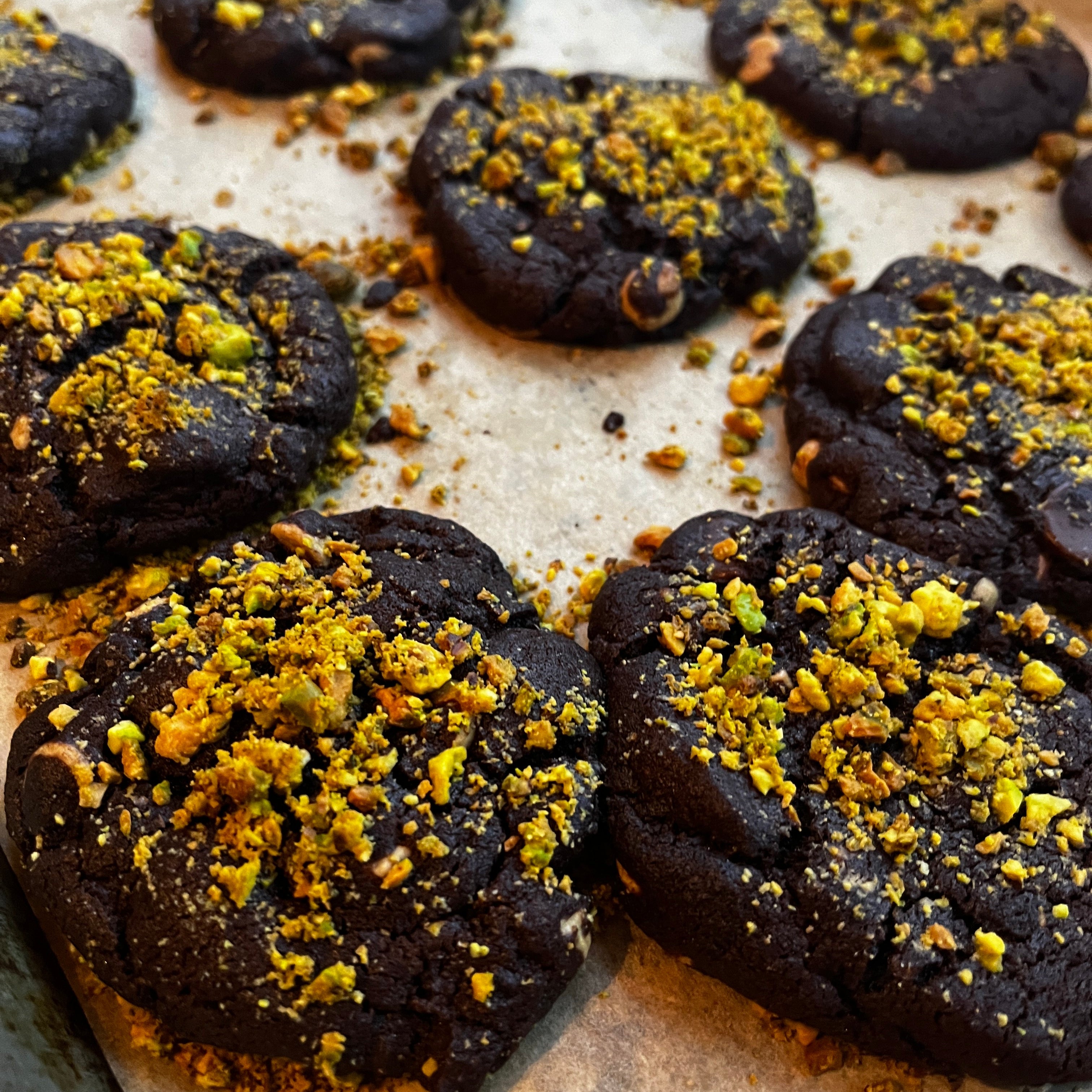 Chocolate cookies with yellow crumb topping on a baking sheet