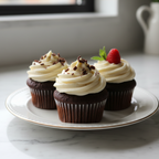 chocolate cupcakes sitting on plate on white marble counter top. cupcakes have simple buttercream frosting
